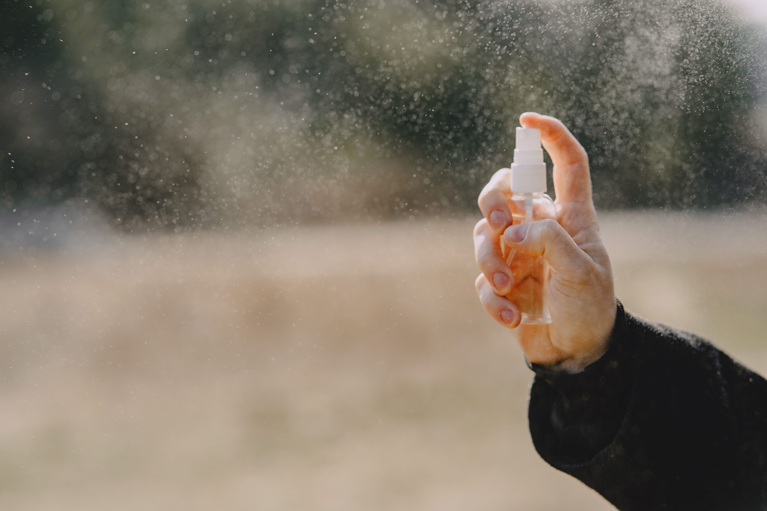 Homme pulvérisant spray anti-moustiques en extérieur